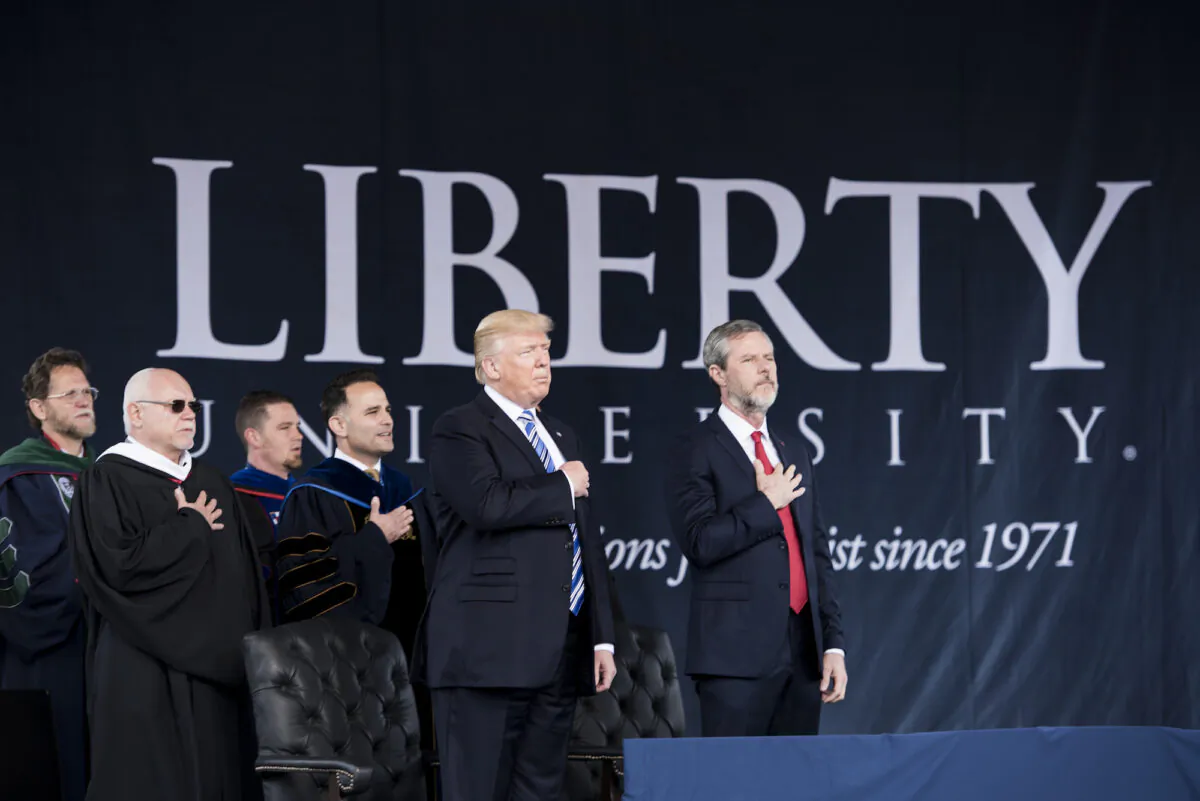 President Donald Trump (2nd R), President of Liberty University Jerry Falwell (R), and others participate in the Pledge of Allegiance during Liberty University's commencement ceremony in Lynchburg, Virginia, on May 13, 2017. (Brendan Smialowski/AFP via Getty Images)