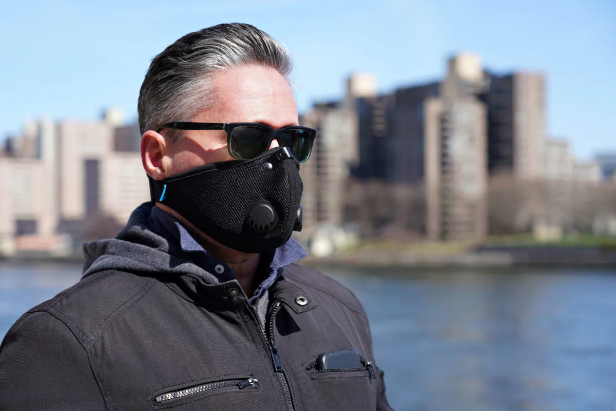 A man walks by the East River wearing a protective mask as the coronavirus continues to spread across the United States, in New York City on March 22, 2020. (Cindy Ord/Getty Images)
