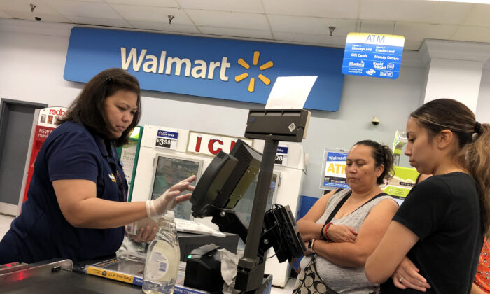 Customers look on as a Walmart cashier rings up their purchases at a Walmart store in California. (Justin Sullivan/Getty Images)