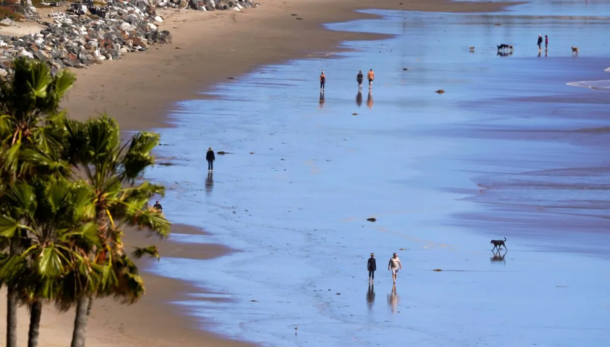 People walk along a beach in Malibu, Calif., on March 23, 2020. (Mark J. Terrill/AP Photo)