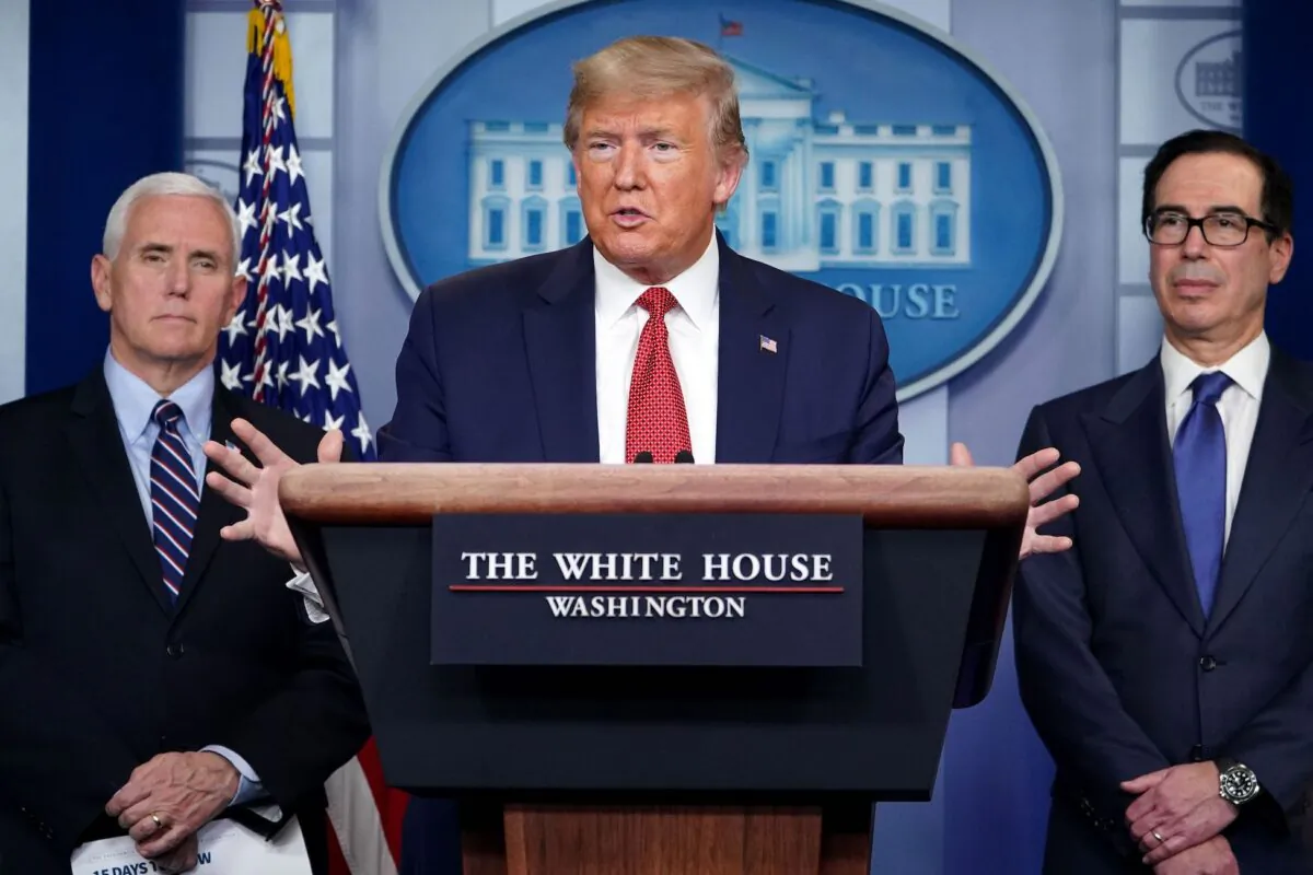 U.S. President Donald Trump speaks during a press conference on the COVID-19 outbreak flanked by Secretary of the Treasury Steven Mnuchin (R) and Vice President Mike Pence at the White House in Washington, D.C., on March 25, 2020. (Mandel Ngan/AFP via Getty Images)