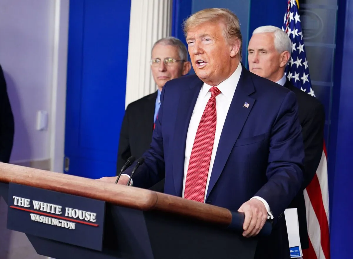 President Donald Trump speaks during the daily briefing on the CCP virus, as Director of the National Institute of Allergy and Infectious Diseases Anthony Fauci (L) and Vice President Mike Pence look on at the White House in Washington on March 25, 2020. (Mandel Ngan/AFP via Getty Images)