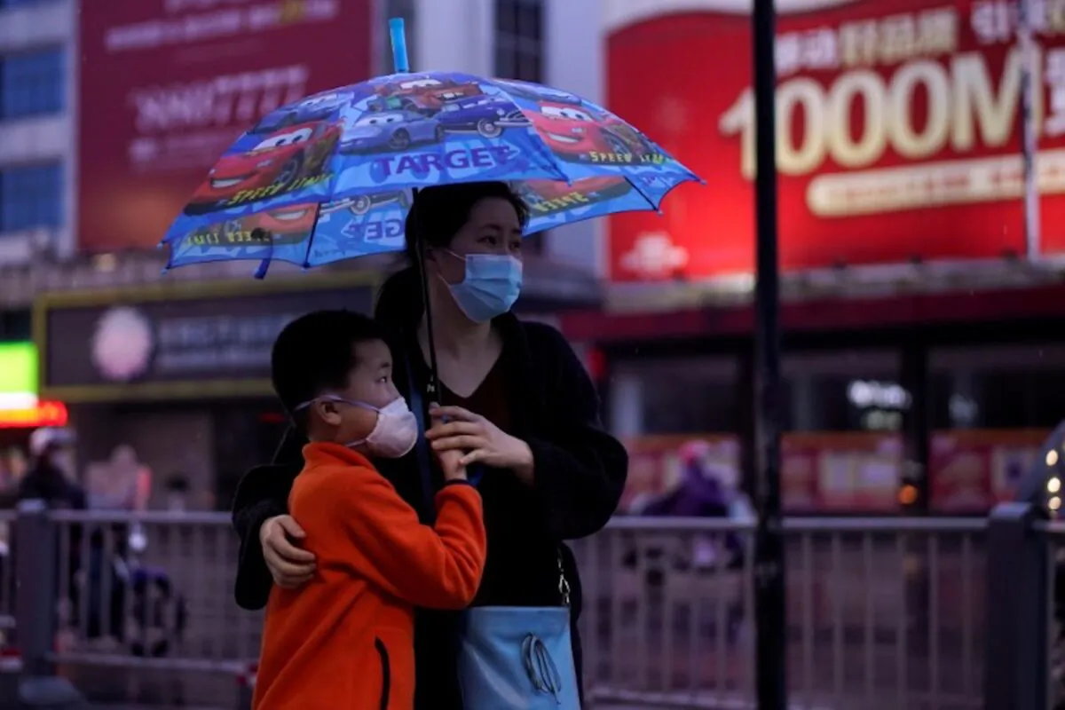 People wearing face masks walk in Jingzhou, after the lockdown was eased in Hubei Province, the epicenter of China's coronavirus disease (COVID-19) outbreak, on March 26, 2020. (Aly Song/Reuters)