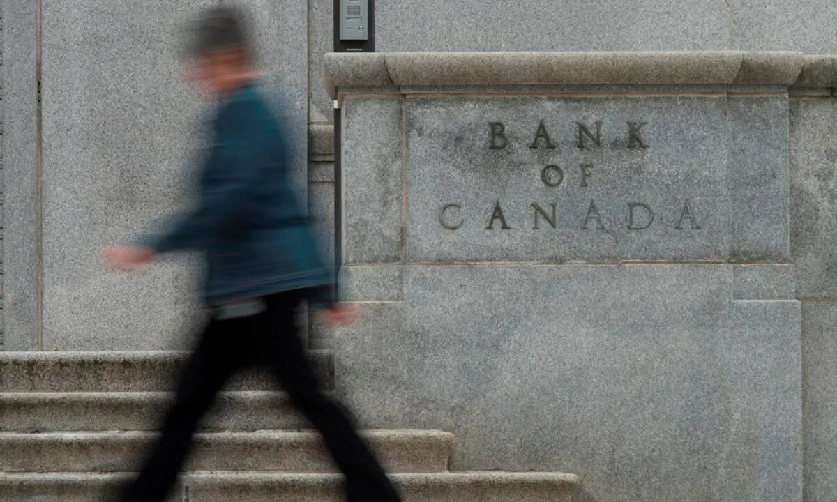 A woman walks past the Bank of Canada bulding in Ottawa in this file photo. (Adrian Wyld/The Canadian Press) 