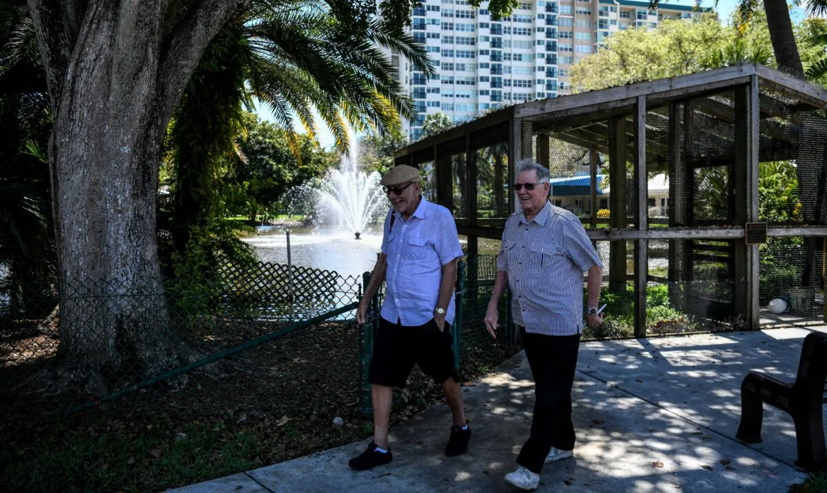 Elderly men walk inside the deserted John Knox Village, a retirement community in Pompano Beach, Fla., on March 21, 2020. (Chandran Khanna/AFP via Getty Images)