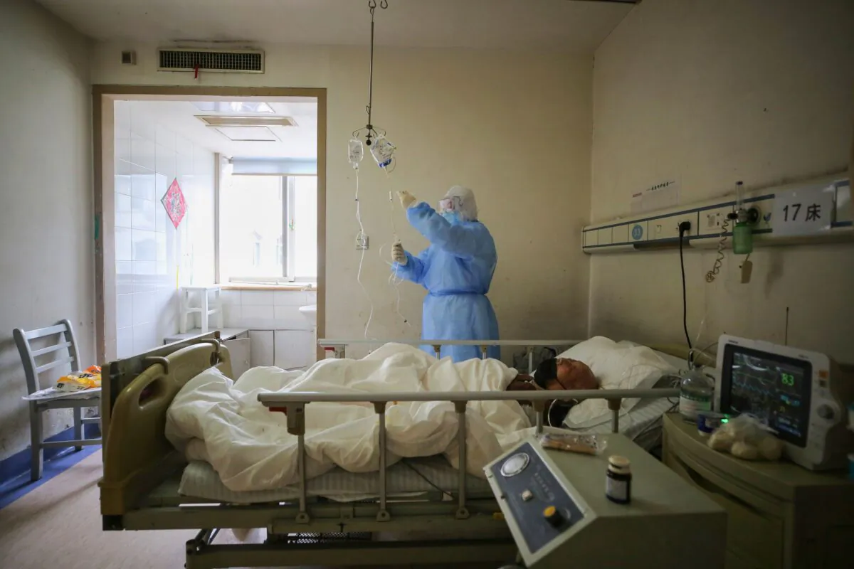 A medical staff member checks medicine used on a patient with COVID-19 at Red Cross Hospital in Wuhan, Hubei province, China, on March 11, 2020.(STR/AFP via Getty Images)