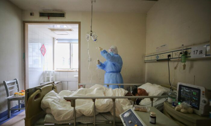 A medical staff member checks medicine used on a patient with COVID-19 at Red Cross Hospital in Wuhan, Hubei province, China, on March 11, 2020.(STR/AFP via Getty Images)