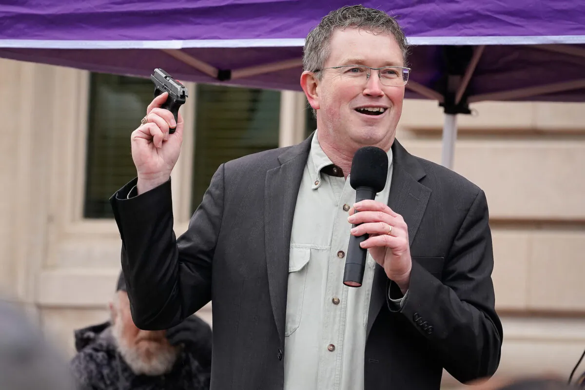 U.S. Rep Thomas Massie (R-Ky.) draws a Ruger handgun from his pocket during a rally in support of the Second Amendment in Frankfort, Ky, in 2020. The five-term incumbent is one of five Kentucky GOP House reps heavily favored to win their May 17 primaries and cruise past Democratic challengers in November. (Bryan Woolston/Getty Images)