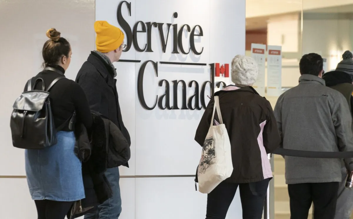 People line up at a Service Canada office in Montreal, Canada, on March 19, 2020. (Paul Chiasson/The Canadian Press)