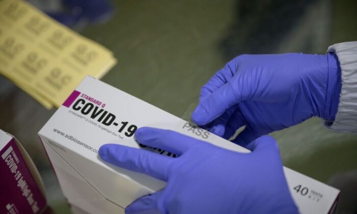 COVID-19 testing kits are packaged on a production line at the SD Biosensor bio-diagnostic company near Cheongju, South Korea, on March 27, 2020. (Ed Jones/AFP via Getty Images) 
