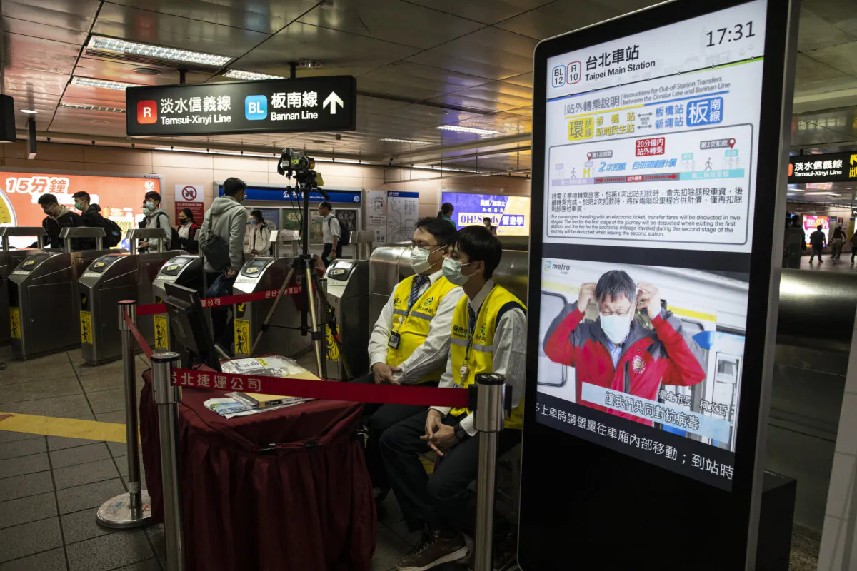 Taipei metro staff in the MRT station monitor the temperatures of passengers with a thermal scanner in Taipei, Taiwan, on March 16, 2020. (Paula Bronstein/Getty Images)