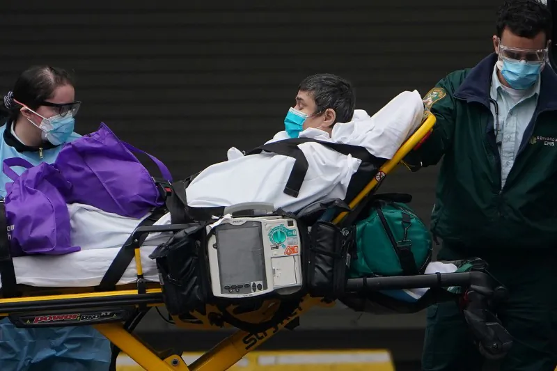 Paramedics move a patient into the hospital during the outbreak of the CCP virus in the Manhattan borough of New York City on March 25, 2020. (Carlo Allegri/Reuters)
