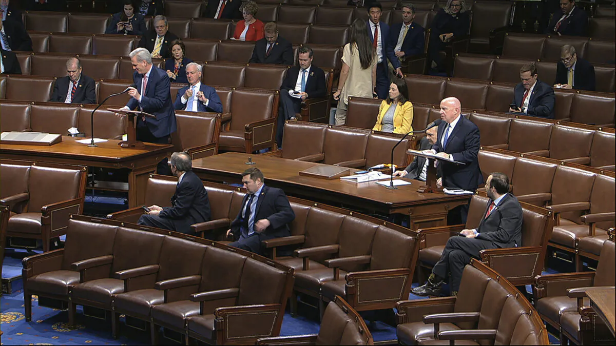 In this image from video, Rep. Kevin McCarthy (R-Calif.), left, and Rep. Kevin Brady (R-Texas) stand as they speak on the floor of the House of Representatives at the U.S. Capitol in Washington on March 27, 2020. (House Television via AP)