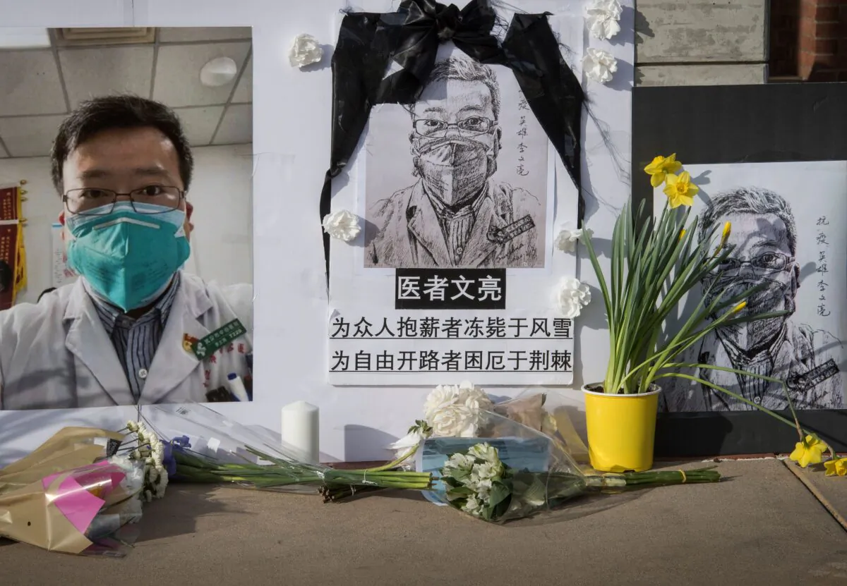 Chinese students and their supporters hold a memorial for Dr Li Wenliang, who was the whistleblower of the CCP Virus that originated in Wuhan, China and caused the doctors death in that city, outside the UCLA campus in Westwood, California, on Feb. 15, 2020. (Mark Ralston/AFP via Getty Images)