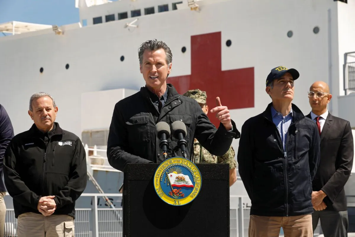 California Gov. Gavin Newsom (C), flanked by (from L) Director Mark Ghilarducci, Cal OES, Los Angeles Mayor Eric Garcetti, and Dr. Mark Ghaly, Secretary of Health and Human Services, speaks in front of the hospital ship USNS Mercy after it arrived into the Port of Los Angeles on March 27, 2020. (Carolyn Cole-Pool/AFP via Getty Images)
