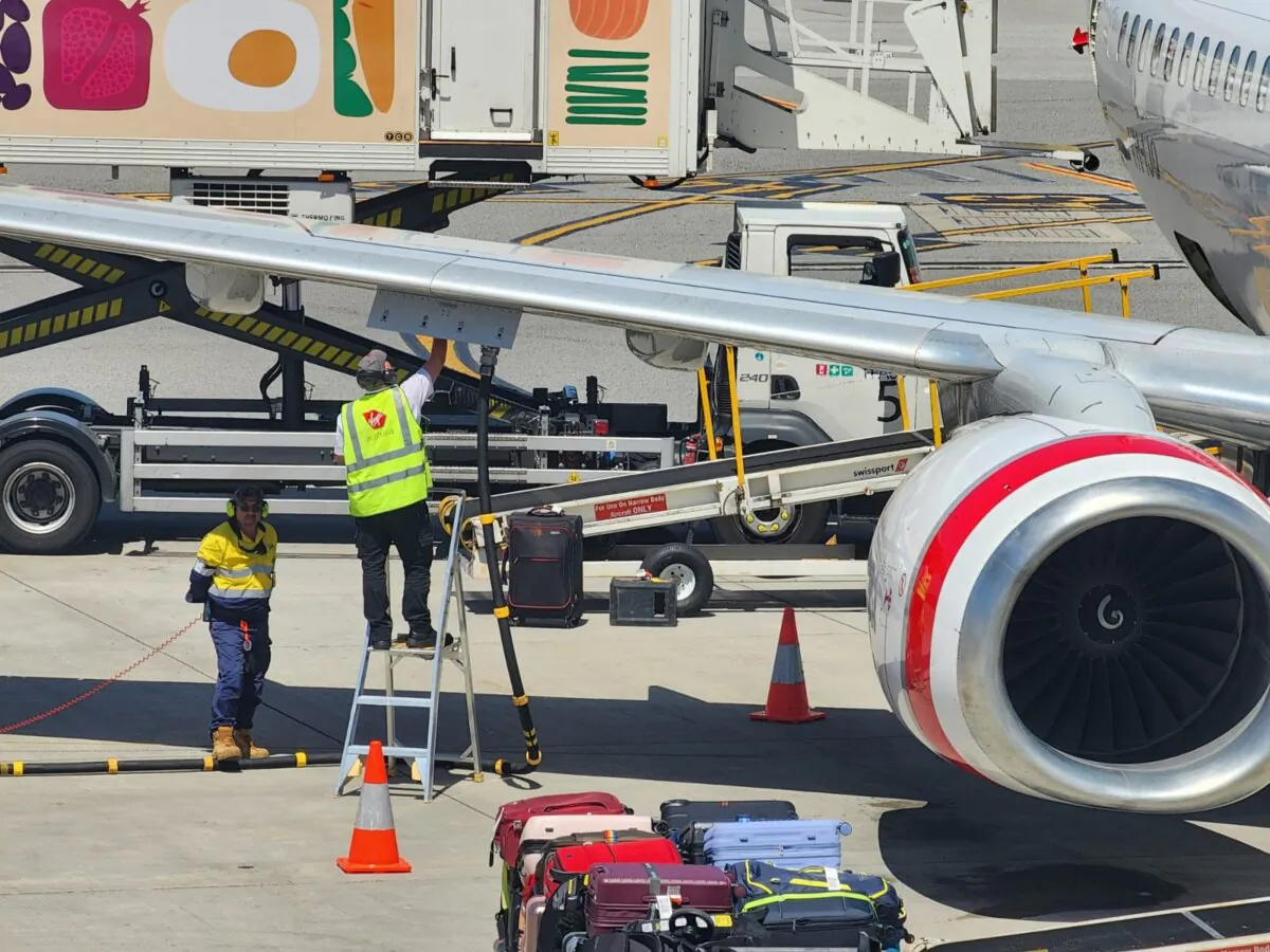 Workers fuel a plane in Perth, Western Australia, on Oct. 24, 2024. (Susan Mortimer/The Epoch Times)
