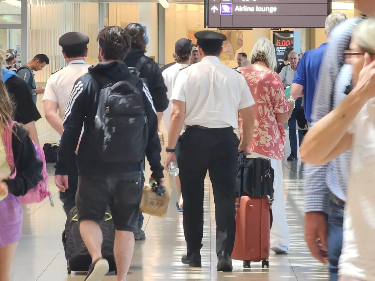 Passengers and airline staff walk through an airport in Perth, Western Australia, on Oct. 24, 2024. (Susan Mortimer/The Epoch Times)