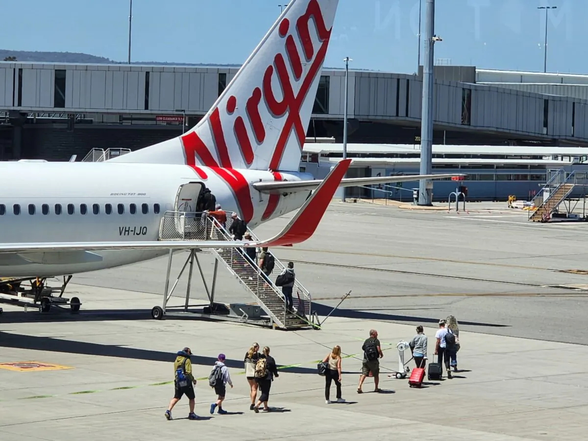 Passengers board a Virgin flight in Perth, Western Australia, on Oct. 24, 2024. (Susan Mortimer/The Epoch Times)