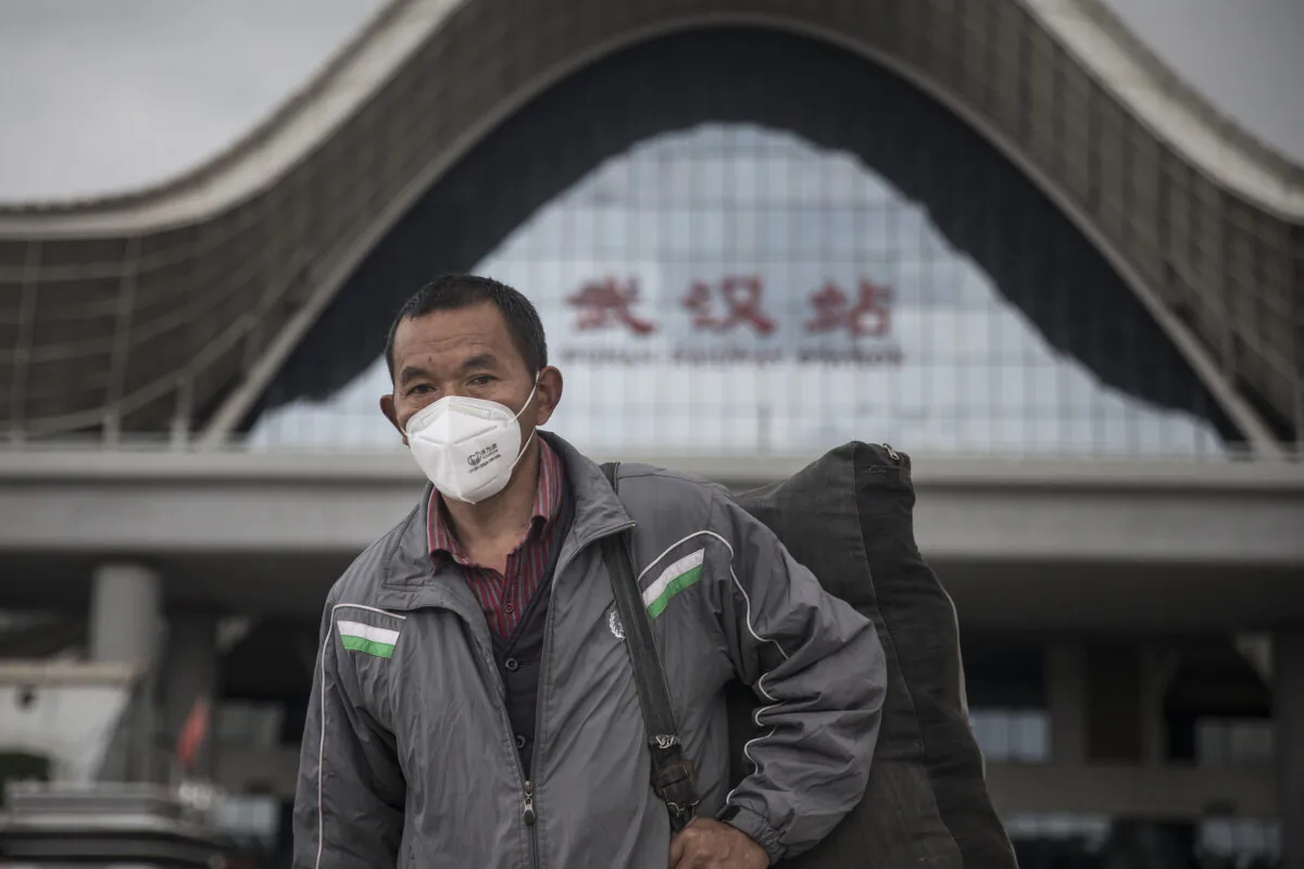A passenger wears a mask after arriving in Wuhan Railway Station in Wuhan, Hubei Province, China, on March 28, 2020. (Getty Images)