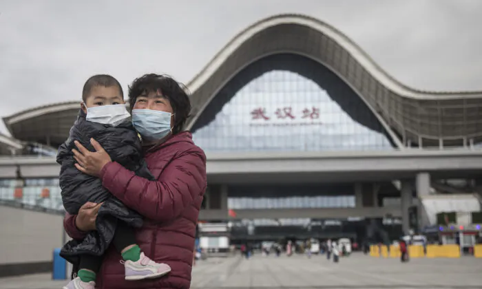 A woman and child arrive at Wuhan Railway Station in Wuhan, Hubei Province, China, on March 28, 2020. (Getty Images)