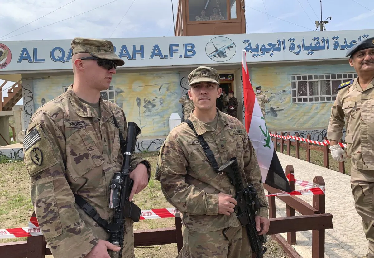 U.S. soldiers stand guard during the hand over ceremony of Qayyarah Airfield, Iraqi Security Forces, in the south of Mosul, Iraq  early on March 27, 2020. (Ali Abdul Hassan/AP Photo)