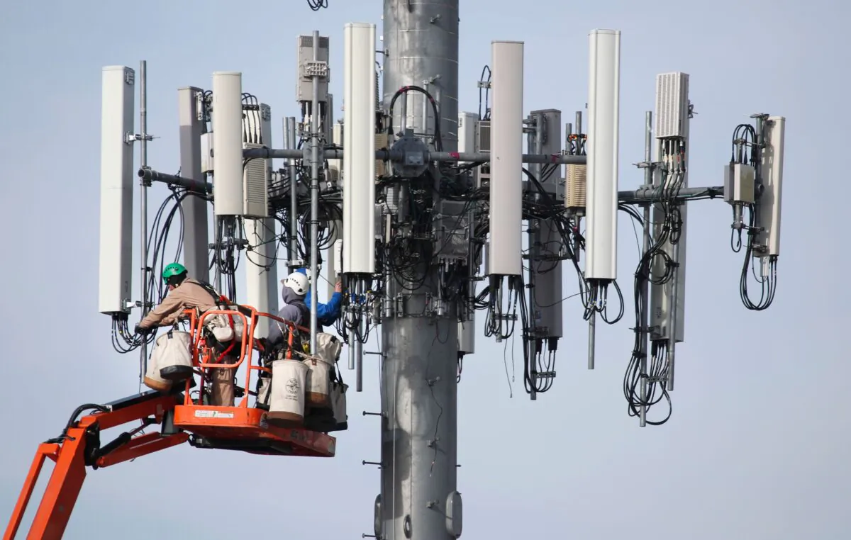 A crew works on a cell tower to update it to handle the new 5G network in Orem, Utah, on Dec. 10, 2019. (George Frey/AFP via Getty Images)