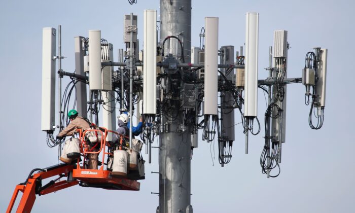 A crew works on a cell tower to update it to handle the new 5G network in Orem, Utah, on Dec. 10, 2019. (George Frey/AFP via Getty Images)