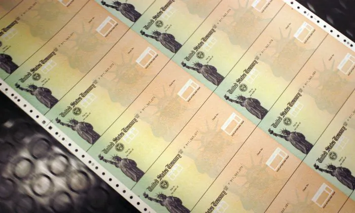 Blank checks are run through a printer at the U.S. Treasury printing facility in Philadelphia, Pennsylvania, on Feb. 11, 2005. (William Thomas Cain/Getty Images)