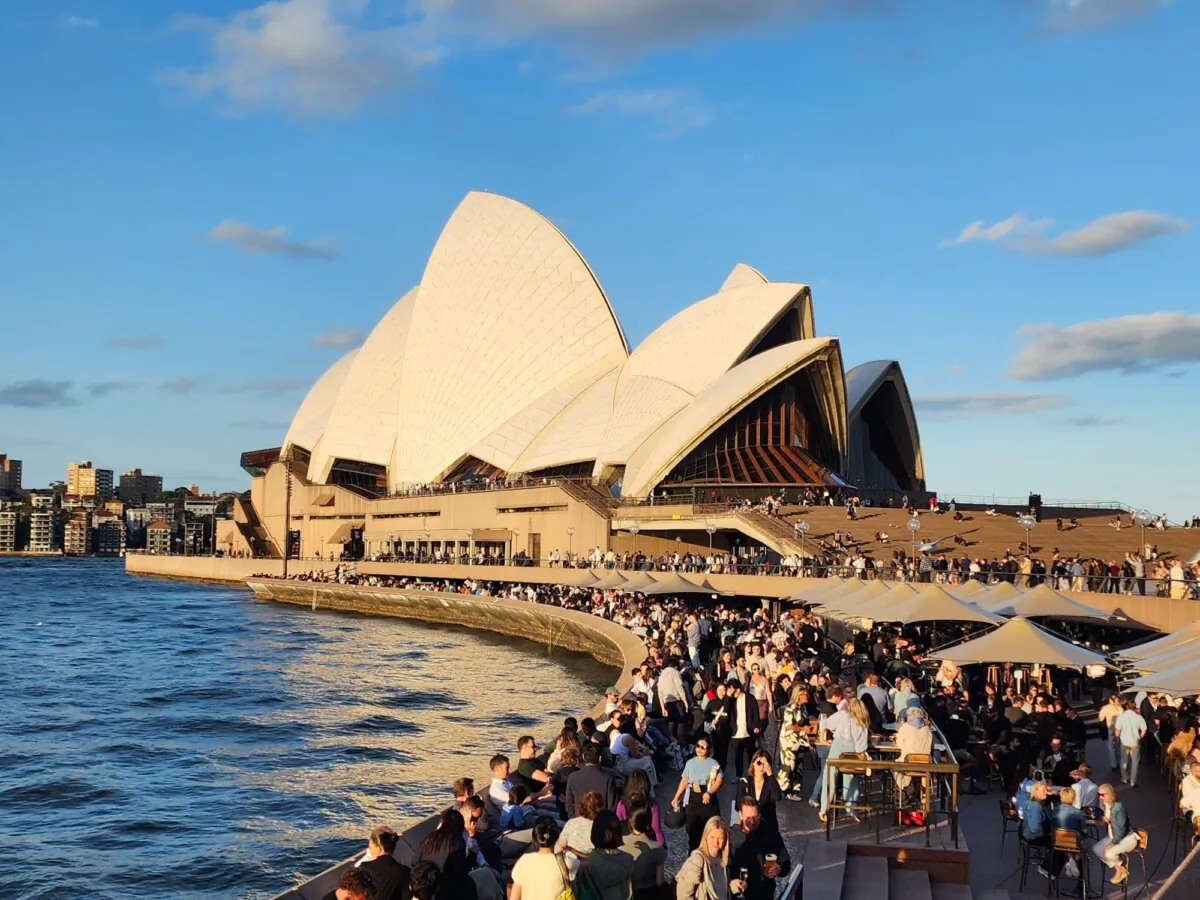 A crowd of people mill about near the Sydney Opera House in Sydney, Australia, on Oct. 25, 2024. (Susan Mortimer/The Epoch Times)