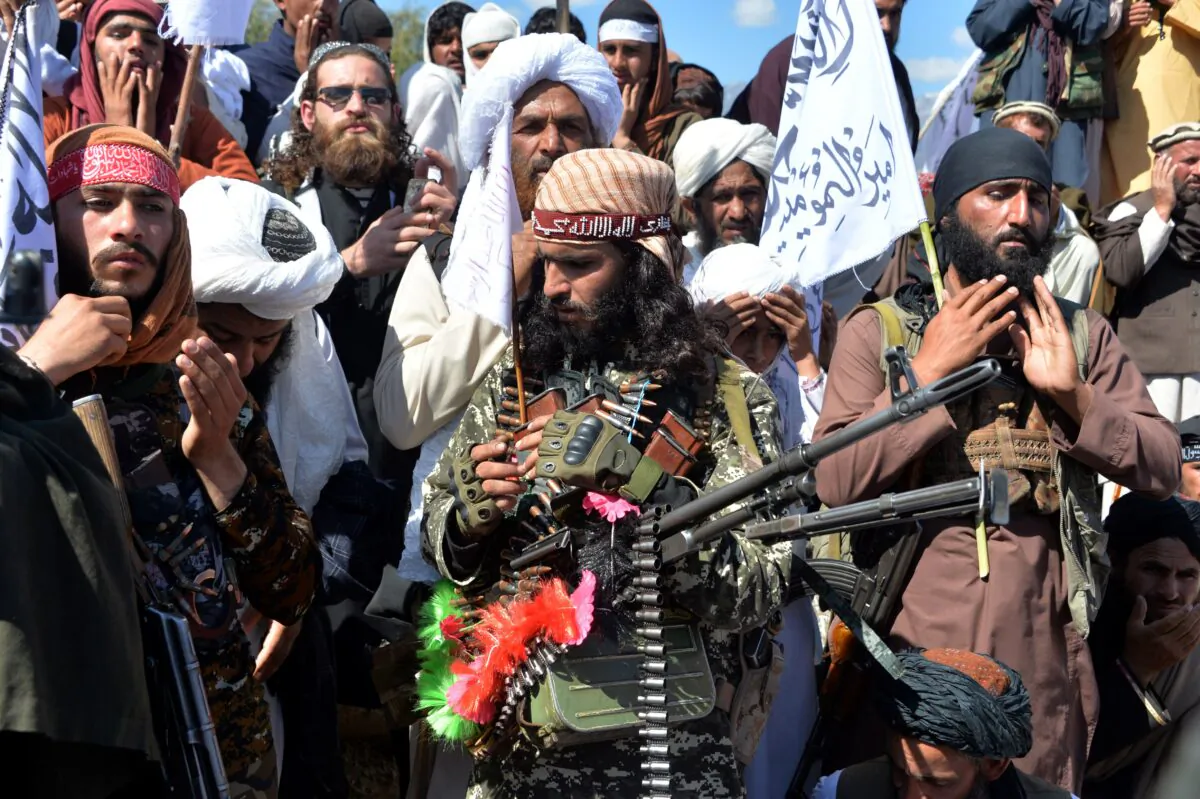 Afghan Taliban fighters and villagers attend a gathering as they celebrate the peace deal and their victory in the Afghan conflict on US in Afghanistan, in Alingar district of Laghman Province on March 2, 2020. (Noorullah Shirzada /AFP via Getty Images)