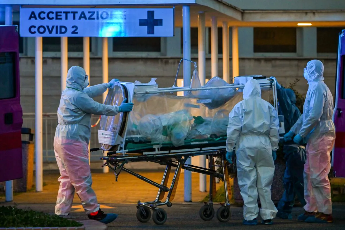 Medical workers take a patient under intensive care into the Columbus Covid 2 temporary hospital, newly built to fight the COVID-19 epidemic, in Rome, Italy, on March 16, 2020. (Andreas Solaro/AFP/Getty Images)