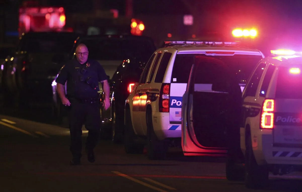 A Phoenix Police officer arrives on the scene of a shooting in Phoenix, Ariz., on March 29, 2020. At least three Phoenix police officers were shot Sunday night on the city's north side, authorities said. (Ross D. Franklin/AP Photo)