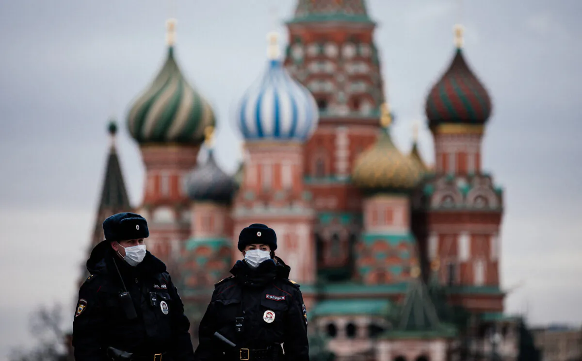 Russian police officers patrol on the deserted Red square in front of Saint Basil's Cathedral in Moscow as the city and its surrounding regions imposed lockdowns today, that were being followed by other Russian regions in a bid to slow the spread of the COVID-19 infection caused by the novel coronavirus, Moscow, Russia , on March 30, 2020. (Dimitar Dilkoff /AFP via Getty Images)