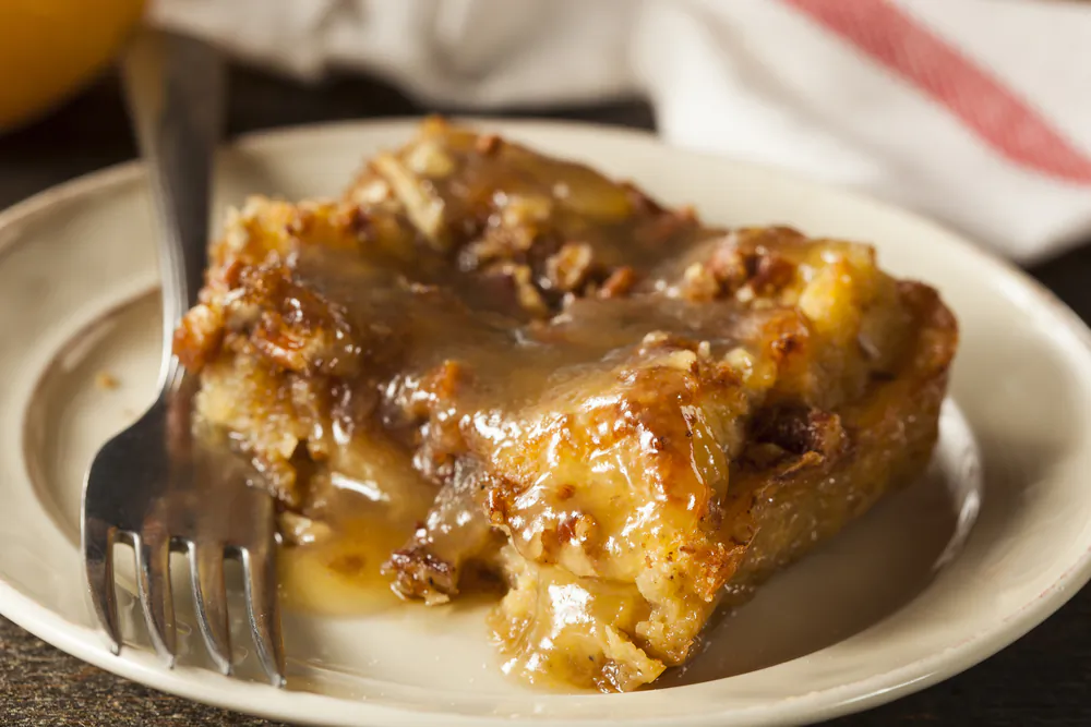Rum sauce elevates a simple, frugal southern bread pudding. (Brent Hofacker/Shutterstock)