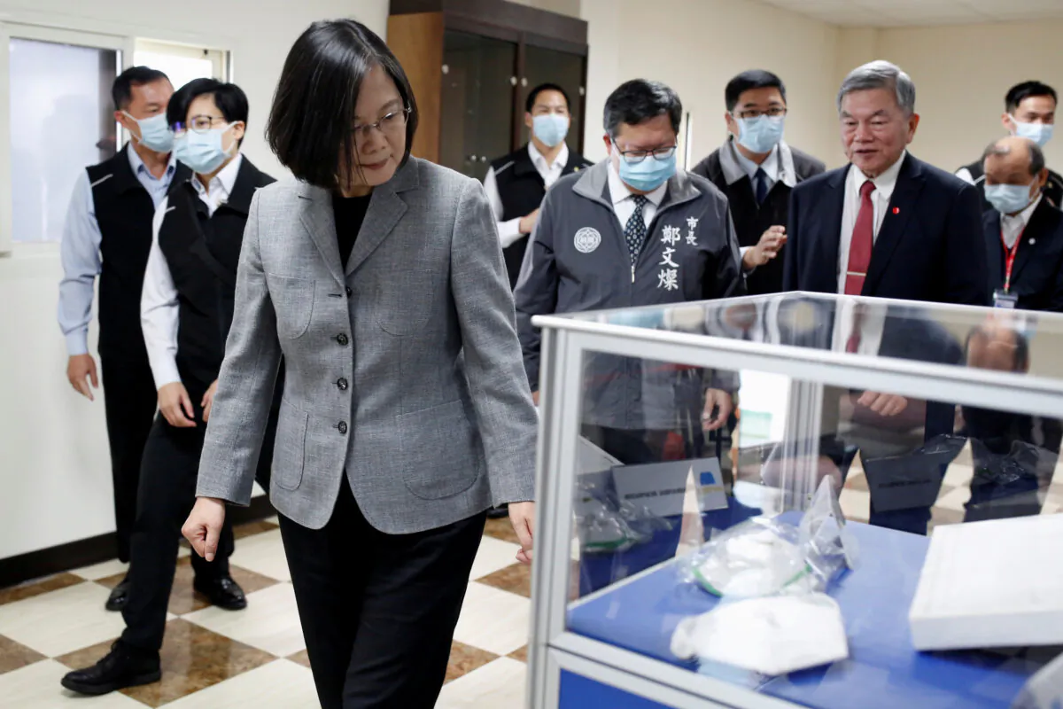 Taiwanese president Tsai Ing-Wen visits a non woven filter fabric factory, where the fabric is used to make surgical face masks, in Taoyuan, Taiwan, on March 30, 2020. (Ann Wang/Reuters)