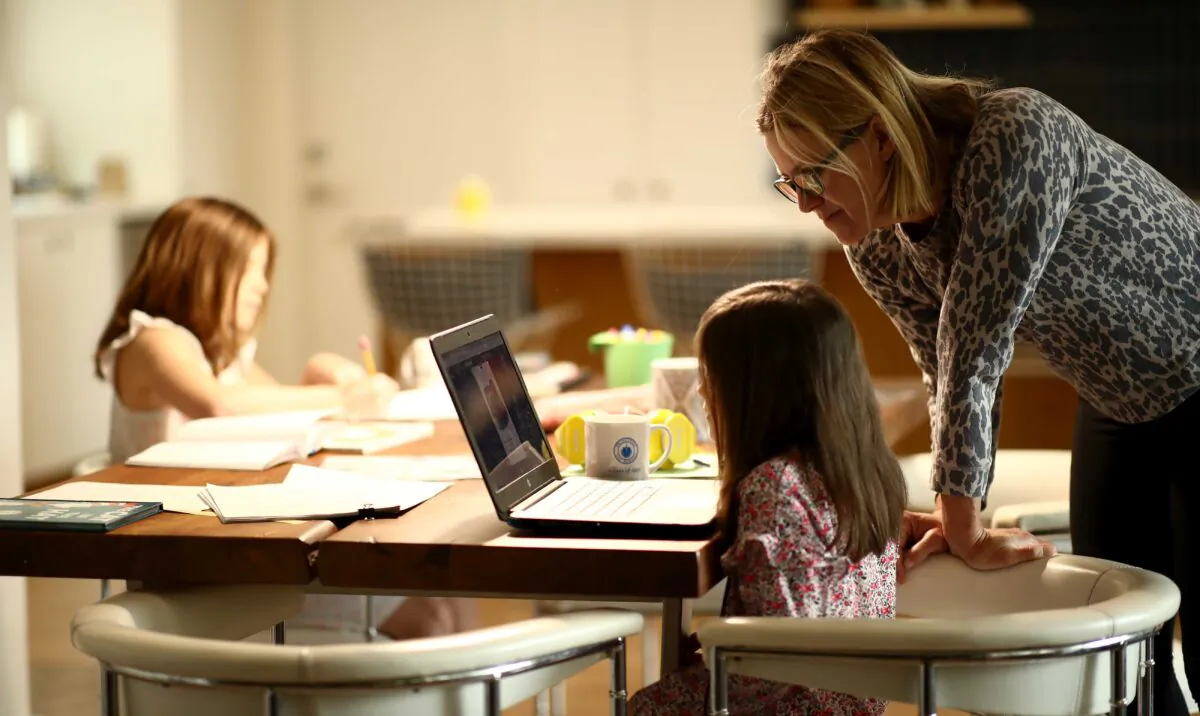 Daisley Kramer helps her kindergarten daughter, Meg, with schoolwork at home in San Anselmo, Calif., on March 18, 2020. (Ezra Shaw/Getty Images)