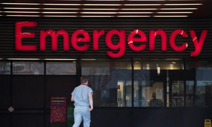 A health care worker is seen making his way into the Emergency dept. of the Vancouver General Hospital in a file photo. (Jonathan Hayward/The Canadian Press)