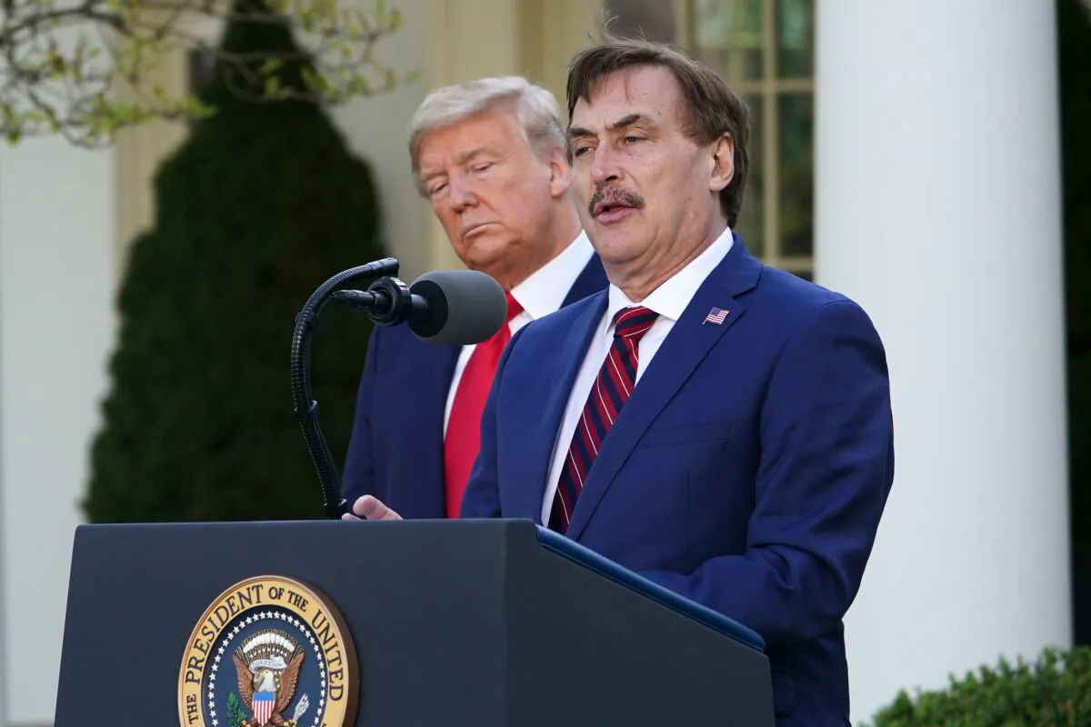 President Donald Trump listens as Michael J. Lindell, CEO of MyPillow Inc., speaks during the daily briefing on the CCP virus, in the Rose Garden of the White House in Washington, on March 30, 2020. (Mandel Ngan/AFP via Getty Images)