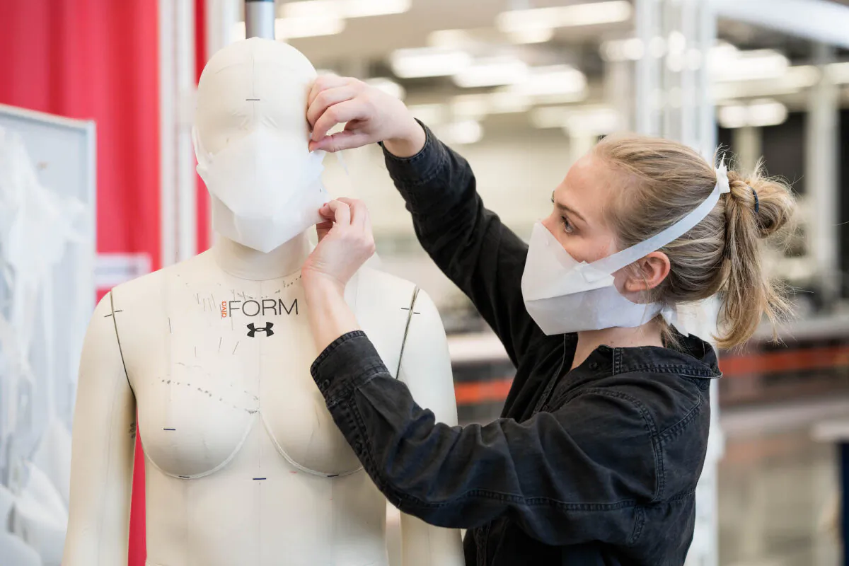 A member of staff at the Under Armour factory in Baltimore makes adjustments to a protective mask in this handout photograph from March 30 2020. (Under Armour)