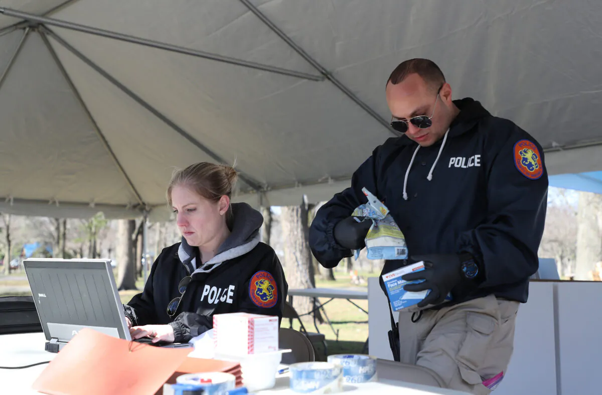 Nassau County police lead a donation drive to collect medical equipment such as N95 surgical masks, nitrile gloves, Tyvek suits, and antibacterial and disinfecting wipes to battle the CCP virus pandemic, at Eisenhower Park in East Meadow, New York, on March 24, 2020. (Al Bello/Getty Images)