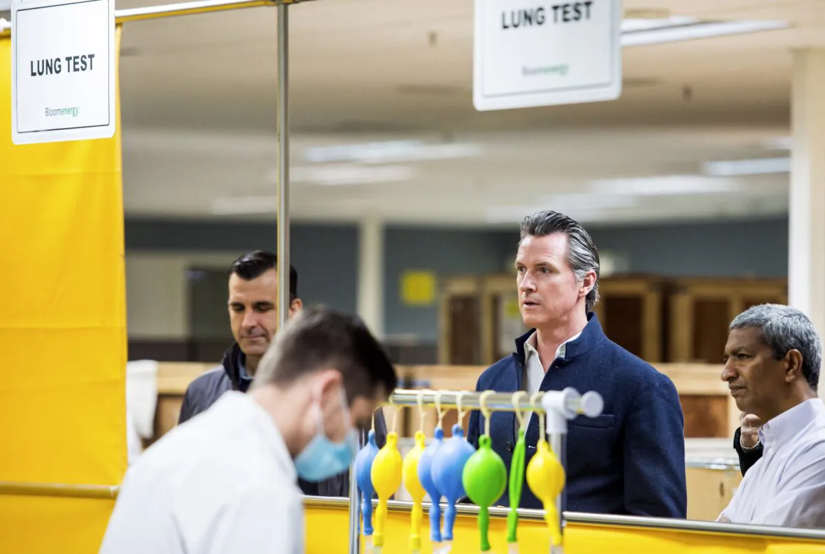 Gov. Gavin Newsom, second from right, is given a tour of the Bloom Energy campus in Sunnyvale, Calif., on March 28, 2020. (Beth LaBerge/KQED via AP, Pool)