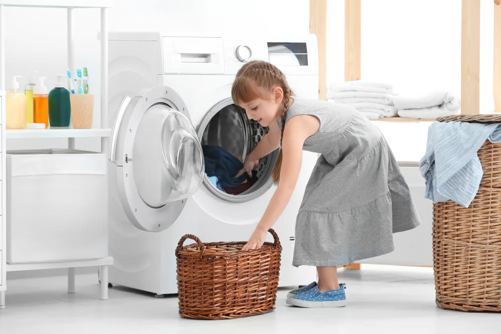 Kids don’t learn how to do laundry in school but they sure do in homeschool. (Africa Studio/Shutterstock)