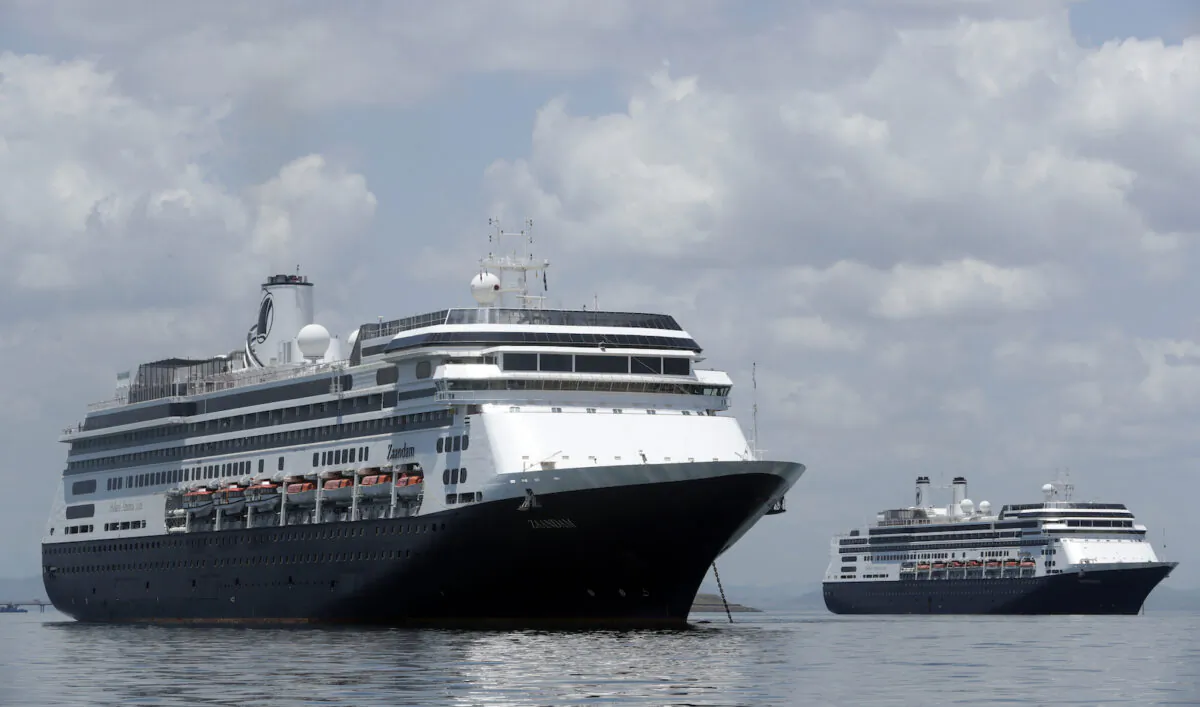 The Zaandam cruise ship (L) carrying some guests with flu-like symptoms, is anchored shortly after it arrives in the bay of Panama City, on March 27, 2020. (Arnulfo Franco/AP)