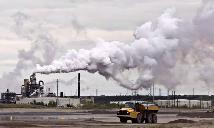 A dump truck works near the Syncrude oilsands extraction facility near the city of Fort McMurray, Alberta, in a file photo. (The Canadian Press/Jason Franson)