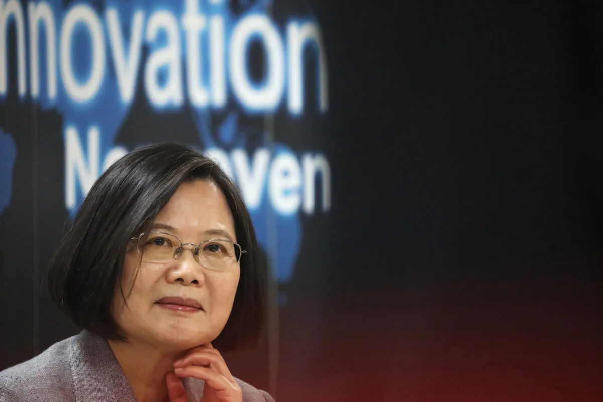 Taiwanese president Tsai Ing-Wen listens to a presentation at a non woven filter fabric factory, where the fabric is used to make surgical face masks, in Taoyuan, Taiwan, on March 30, 2020. (Ann Wang/Reuters)