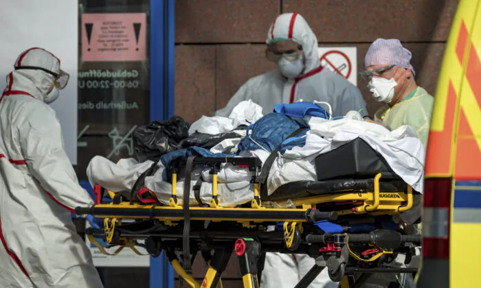 A patient with COVID-19, flown in from Italy, is admitted to a hospital in Leipzig, Germany, on March 25, 2020. (Hendrik Schmidt/dpa via AP, File)

