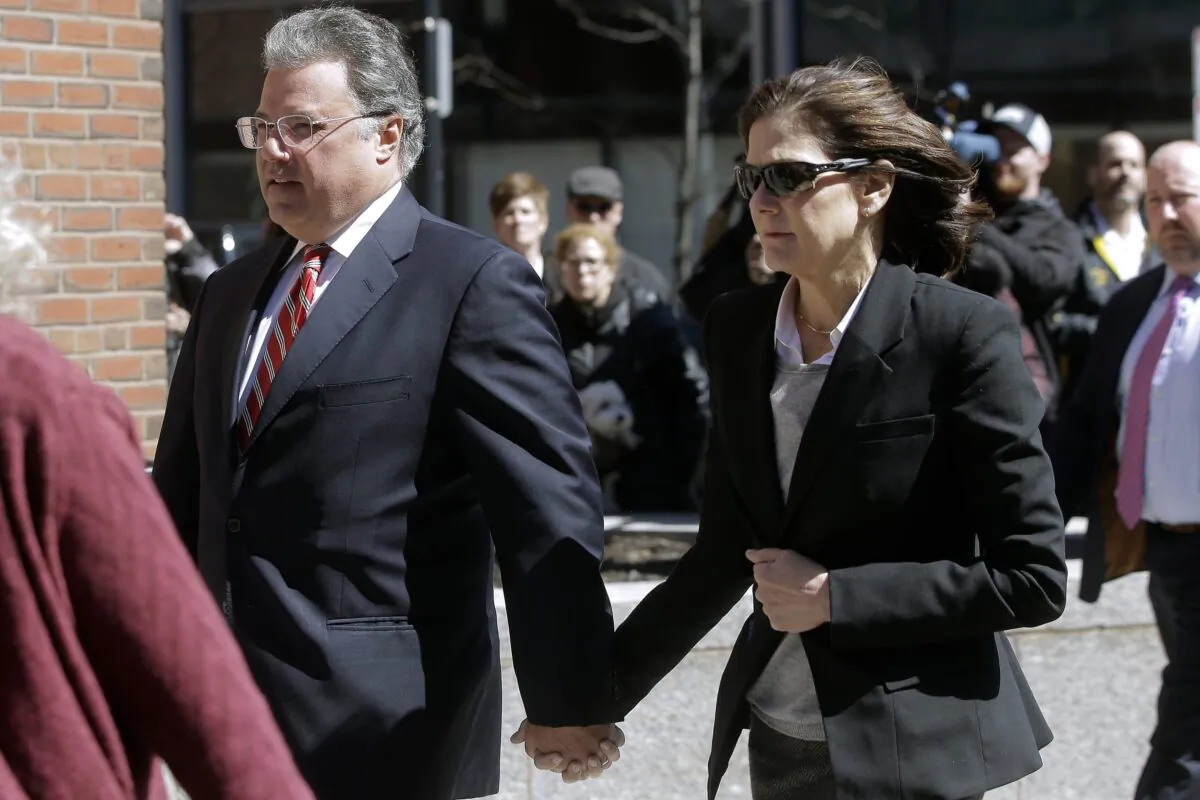 Manuel and Elizabeth Henriquez arrive at federal court in Boston to face charges in a nationwide college admissions bribery scandal, in Boston on April 3, 2019. (Steven Senne/AP Photo/ File)