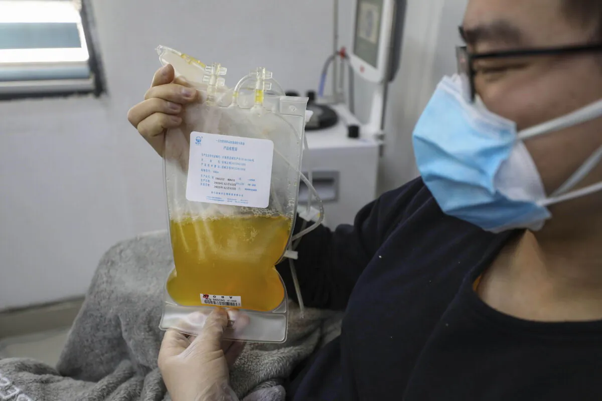 Dr. Zhou Min, a recovered COVID-19 patient who exited a 14-day quarantine, donates plasma in the city's blood center in Wuhan in central China's Hubei province on Feb. 18, 2020. (Chinatopix via AP, File)