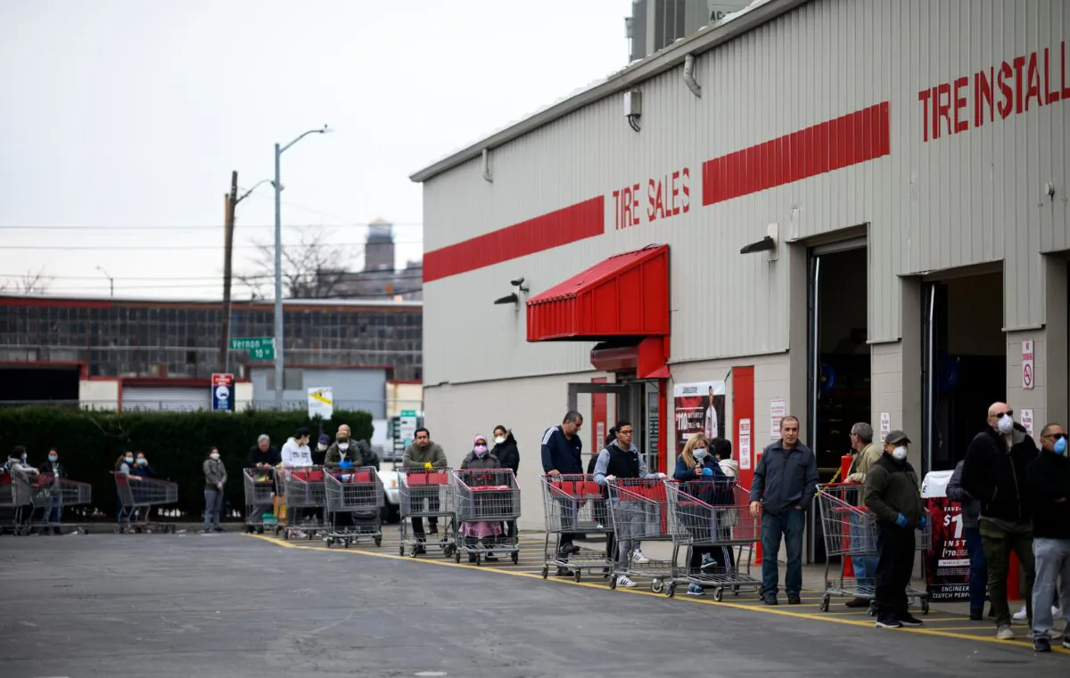 People keep social distance as they queue in front of a Costco wholesale market in Queens, New York City, on March 30, 2020. (Johannes Eisele/AFP via Getty Images)