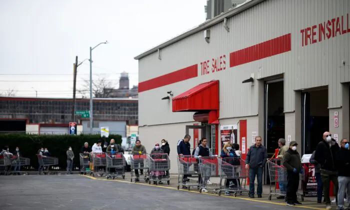 People keep social distance as they queue in front of a Costco wholesale market in Queens, New York City, on March 30, 2020. (Johannes Eisele/AFP via Getty Images)